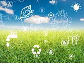 Różne ikony kojarzące się z ekologią (drzewa, liście, słońce, elektrownia wiatrowa) połączone w sieć, w tle łąka i pogodne niebo.