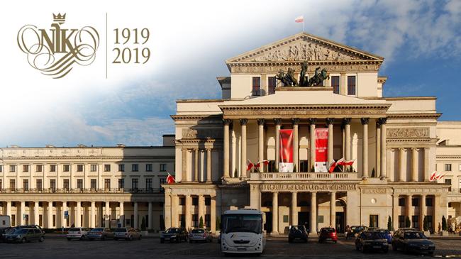 Logo obchodów stulecia NIK obok budynek Teatru Wielkiego w Warszawie