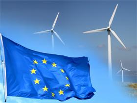 Flaga Unii Europejskiej w tle elektrownia wiatrowa
