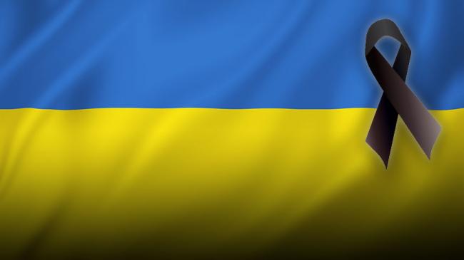 Ukrainian flag with a black ribbon