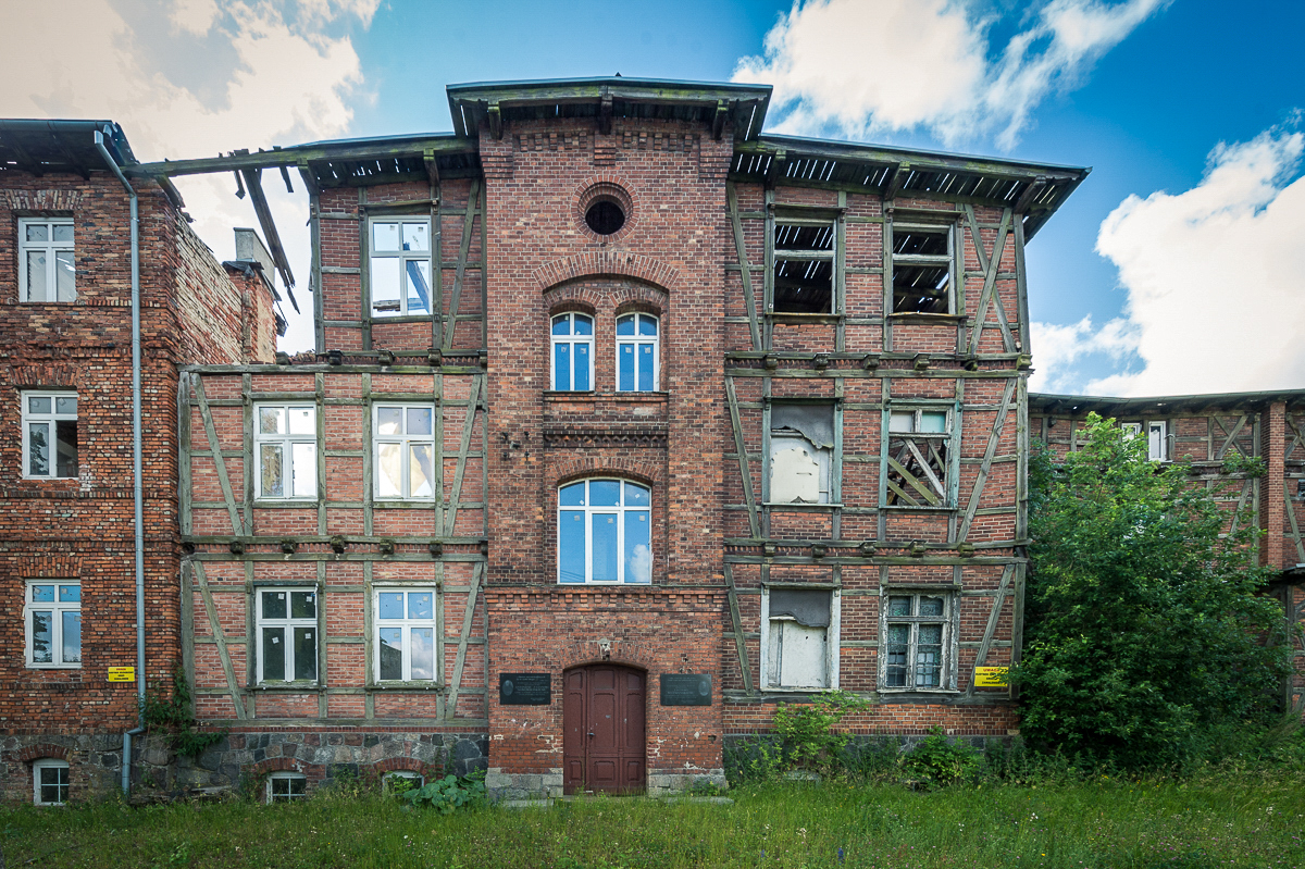 The front of the former KL Soldau building in Działdowo, apparent damages of the roof and walls of the building 