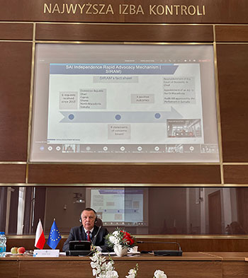 EUROSAI online conference on SAI independence (Marian Banaś in the conference room with a fragment of presentation on the screen) 
